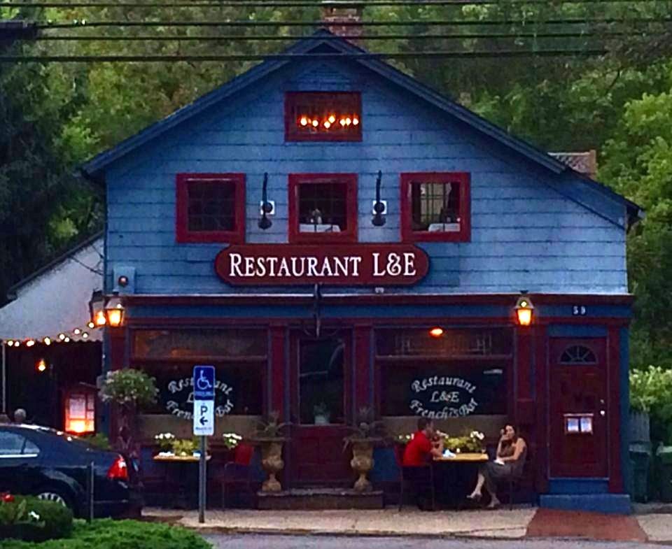 Restaurant L&E at dusk, blue clapboard and red trim on Main Street